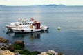 Two old boats moored at a stone jetty in the calm water. Winter cloudy day. Istanbul, Turkey Royalty Free Stock Photo