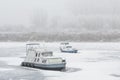 Two old boats wrecked in a frozen river Tisa