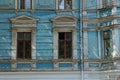 Two old brown windows on a blue concrete wall Royalty Free Stock Photo