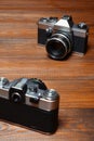 Two old cameras on wooden background. Royalty Free Stock Photo