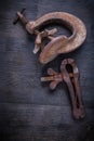 Two old clamps on vintage wood board Royalty Free Stock Photo