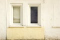 Two Old Closed Windows in the Old White Concrete Wall Royalty Free Stock Photo