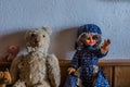 two old dolls on a cabinet in a house Royalty Free Stock Photo