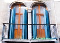 Two old door-windows with a slightly crooked balcony Royalty Free Stock Photo