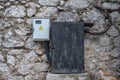 Two old electrical boxes on a stone wall Royalty Free Stock Photo