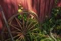 Old wooden wagon wheels resting on a barn Royalty Free Stock Photo