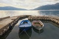 Two old fishing boats in small harbor on cloudy autumn day. Montenegro, Bay of Kotor Royalty Free Stock Photo