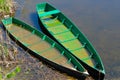 Two old fishing boats thrown on the shore . Worn and faded wooden boats in the yellow grass on the lake shore