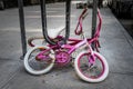 Two old girl`s bicycles, rusty and long forgotten, chained to a bike rack on a New York City street