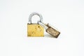 Two old gold-colored padlocks locked and connected to each other placed upright Royalty Free Stock Photo