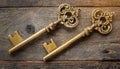 Two old golden keys on wooden table, top view. Royalty Free Stock Photo