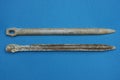 Two old gray aluminum army german tent pegs