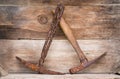 Two old iron rusted mining picks on wood shelf Royalty Free Stock Photo