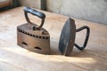 Two old irons on a table Royalty Free Stock Photo