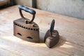 Two old irons on a table Royalty Free Stock Photo