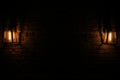 two old lanterns dim light dark wall Royalty Free Stock Photo