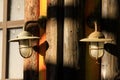 Two old lanterns with glass bulbs and safety grille