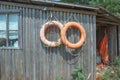 Old lifebuoys on a log wall