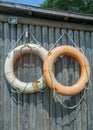 Old lifebuoys on a log wall