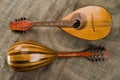 Two old mandolins on a background of rough burlap texture. View from different sides Royalty Free Stock Photo