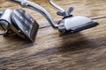 Two old manual haircut machine on old wooden scrached background.