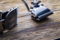 Two old manual haircut machine on old wooden scrached background.