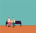 Two old men with medical face masks sits on the bench in the park during a pandemic Coronavirus Covid-19. Social distansing concep Royalty Free Stock Photo