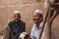 Two old men selling handmade hats