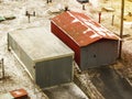 Two old metal car garages as seen from above in winter. One old gray red metal garage on a fence wall in a rural street. Old metal Royalty Free Stock Photo