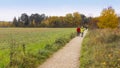 Two old people walking in the park together. Background is a big Royalty Free Stock Photo