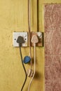 old electrical sockets with plugs on dirty wall Royalty Free Stock Photo