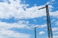 Two old railway masts in front of a dramatic cloudy sky Royalty Free Stock Photo