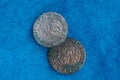 Two old rare silver coins on blue woolen cloth