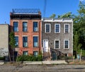 Two old row houses on a cobble stone street in Red Hook, Brooklyn, NYC