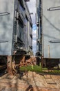 Two old rusted antique railroad train cars coupled together.