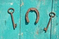 Two old rusty historical key and luck symbol horseshoe on wall Royalty Free Stock Photo