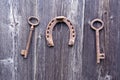 Two old rusty historical key and luck symbol horseshoe on wall Royalty Free Stock Photo
