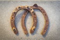 Two old rusty horseshoe on a grey stone background. Good luck symbol. Vintage concept. Royalty Free Stock Photo