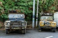 Two old rusty peeled paint farm trucks in an Asian village