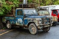 Two old rusty peeled paint farm trucks in an Asian village