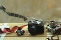 Two old school vintage photo cameras and scattered films on light brown table. One in brown retro leather case holder. Blurred Royalty Free Stock Photo