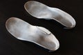 Old, shabby orthopedic insoles on the table