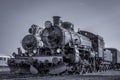 Two old steam locomotives standing side by side Royalty Free Stock Photo