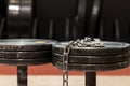Two old and used gym black metal dumbbells with silver chain. Gym equipment Royalty Free Stock Photo
