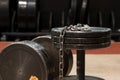 Two old and used gym black metal dumbbells with silver chain. Gym equipment Royalty Free Stock Photo