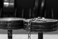 Two old and used gym black metal dumbbells with silver chain. Gym equipment. Black and white image Royalty Free Stock Photo