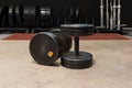 Two old and used gym black metal dumbbells with silver chain. Gym equipment Royalty Free Stock Photo