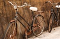 Two old vintage bicycles rusted near a concrete wall. Royalty Free Stock Photo