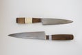 Two Old vintage homemade kitchen or household knife with a wooden handle and a blade from a saw blade on a white