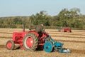 Two old vintage red tractors ploughing Royalty Free Stock Photo